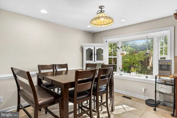 a view of a dining room with furniture and a floor to ceiling window