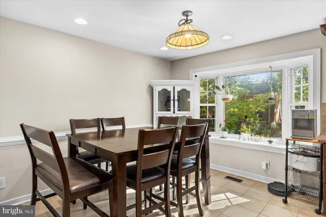 a view of a dining room with furniture and a floor to ceiling window