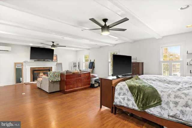 a bedroom with furniture fireplace and window