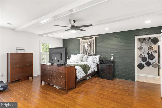 a bed room with a bed and a ceiling fan