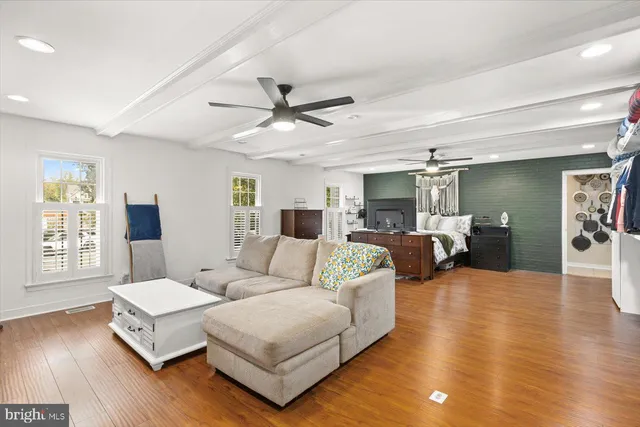 a living room with furniture wooden floor and window