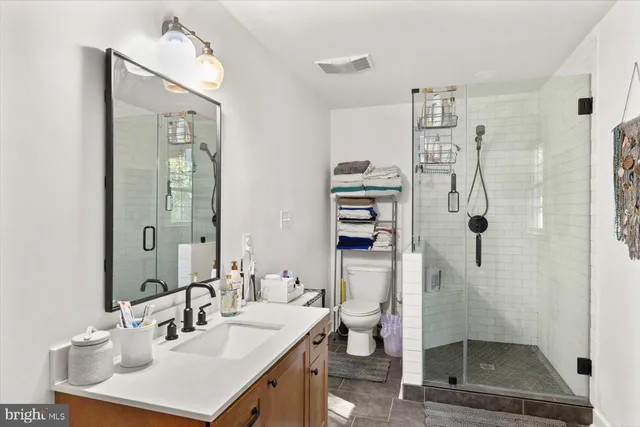 a bathroom with a sink toilet and shower