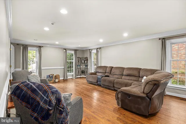 a living room with furniture a large window with wooden floor
