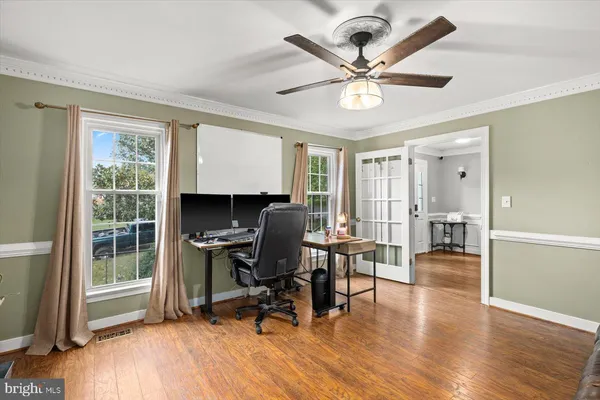 a workspace with wooden floor and a window