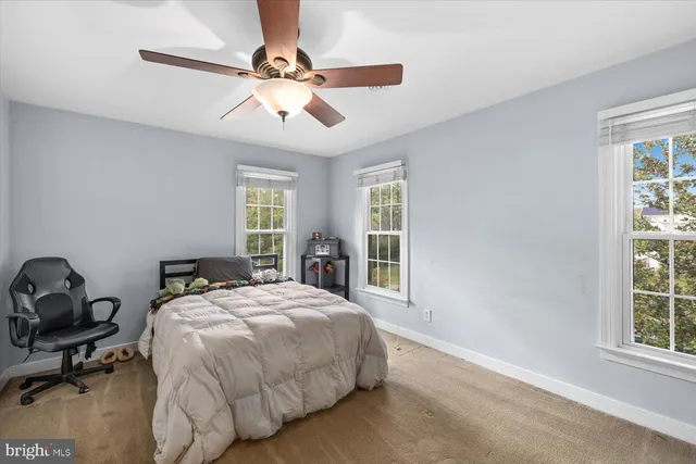 a bed sitting in a bedroom next to a window