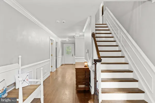 a view of entryway and hall with wooden floor