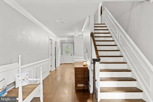 a view of entryway and hall with wooden floor