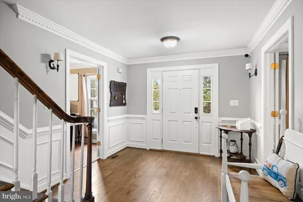 a view of an entryway with workspace and livingroom view