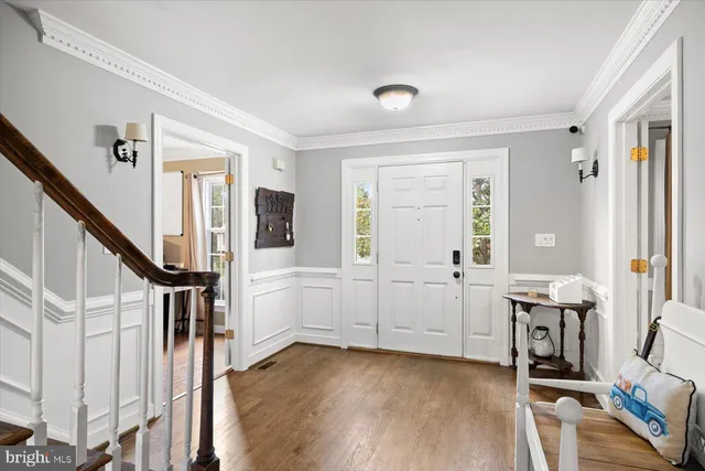 a view of an entryway with workspace and livingroom view