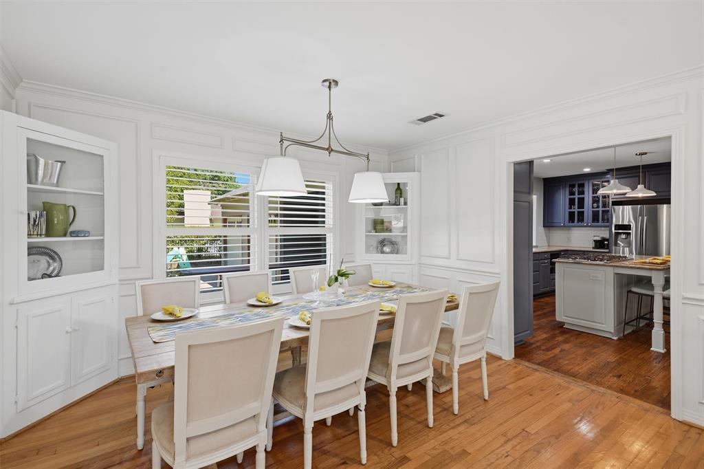 3712 Brighton Road Fort Worth, TX 76109 - Photo 4 of 33 Elegant formal dining room with built-in display cabinets, wall wainscoting, and seamless flow into the kitchen.