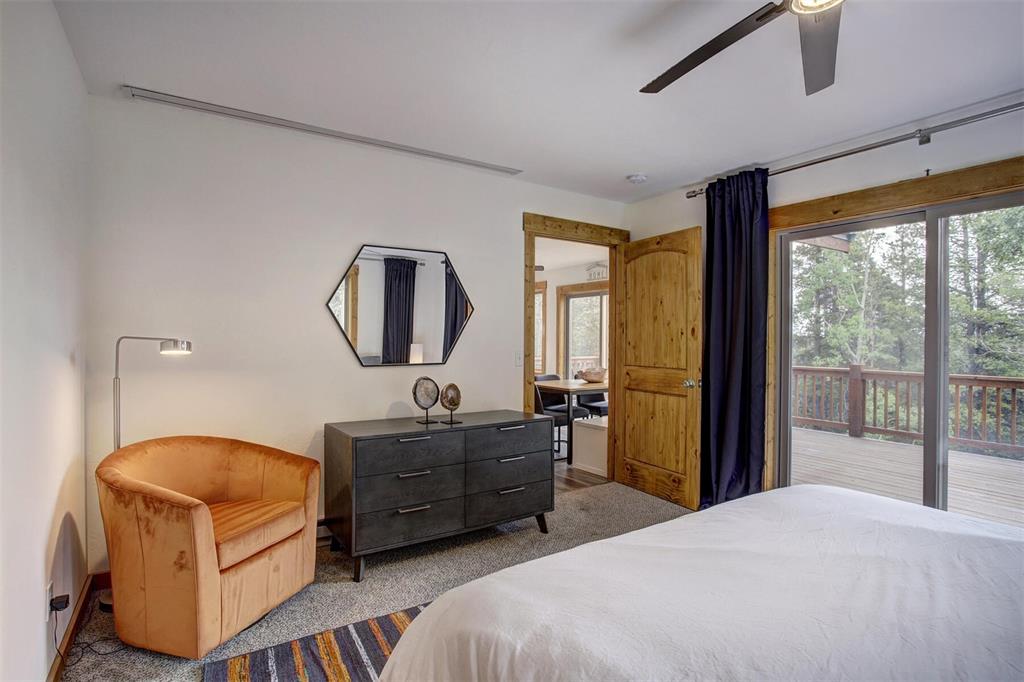 1002 Venture Road Fairplay, CO 80440 - Photo 13 of 35 a bedroom with a bed dresser and a large mirror