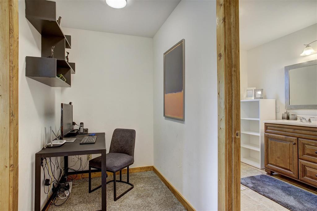 1002 Venture Road Fairplay, CO 80440 - Photo 16 of 35 a view of a workspace room with wooden floor cabinet and windows