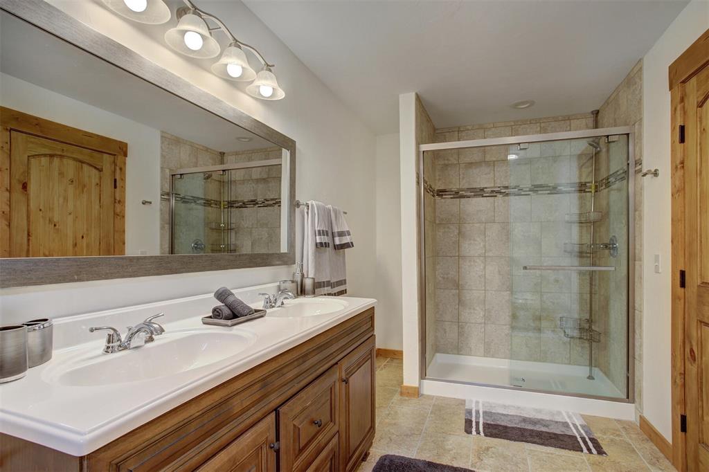 1002 Venture Road Fairplay, CO 80440 - Photo 17 of 35 a bathroom with a sink double vanity and a shower