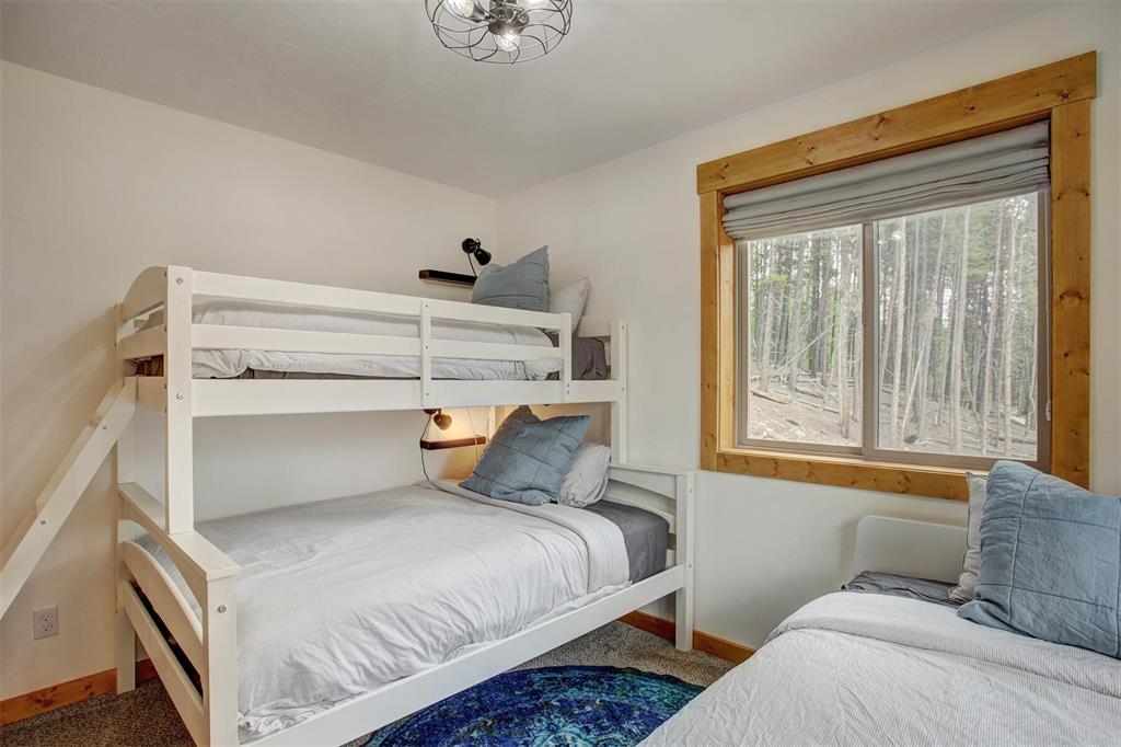 1002 Venture Road Fairplay, CO 80440 - Photo 18 of 35 a bedroom with a bed and windows