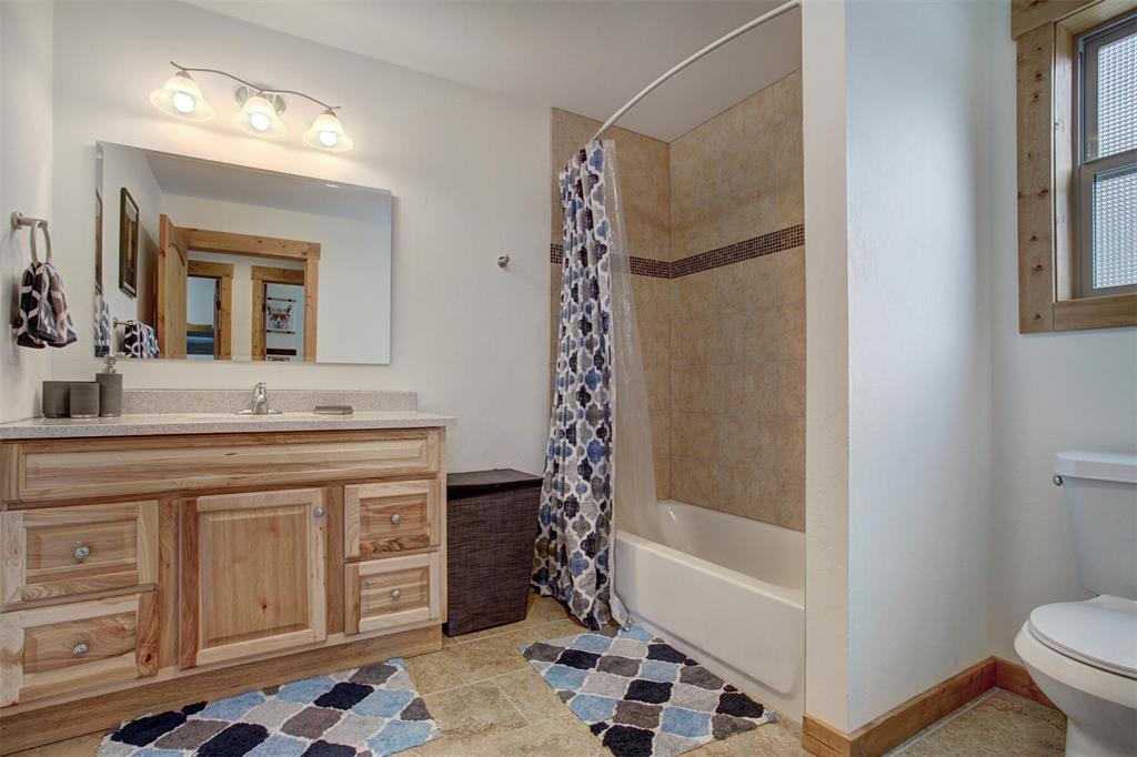 1002 Venture Road Fairplay, CO 80440 - Photo 20 of 35 a bathroom with a bathtub sink and mirror
