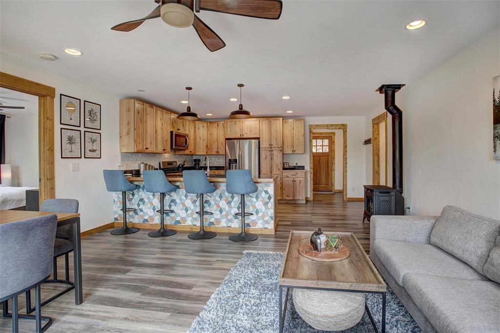 1002 Venture Road Fairplay, CO 80440 - Photo 9 of 35 a living room with kitchen island furniture and a chandelier
