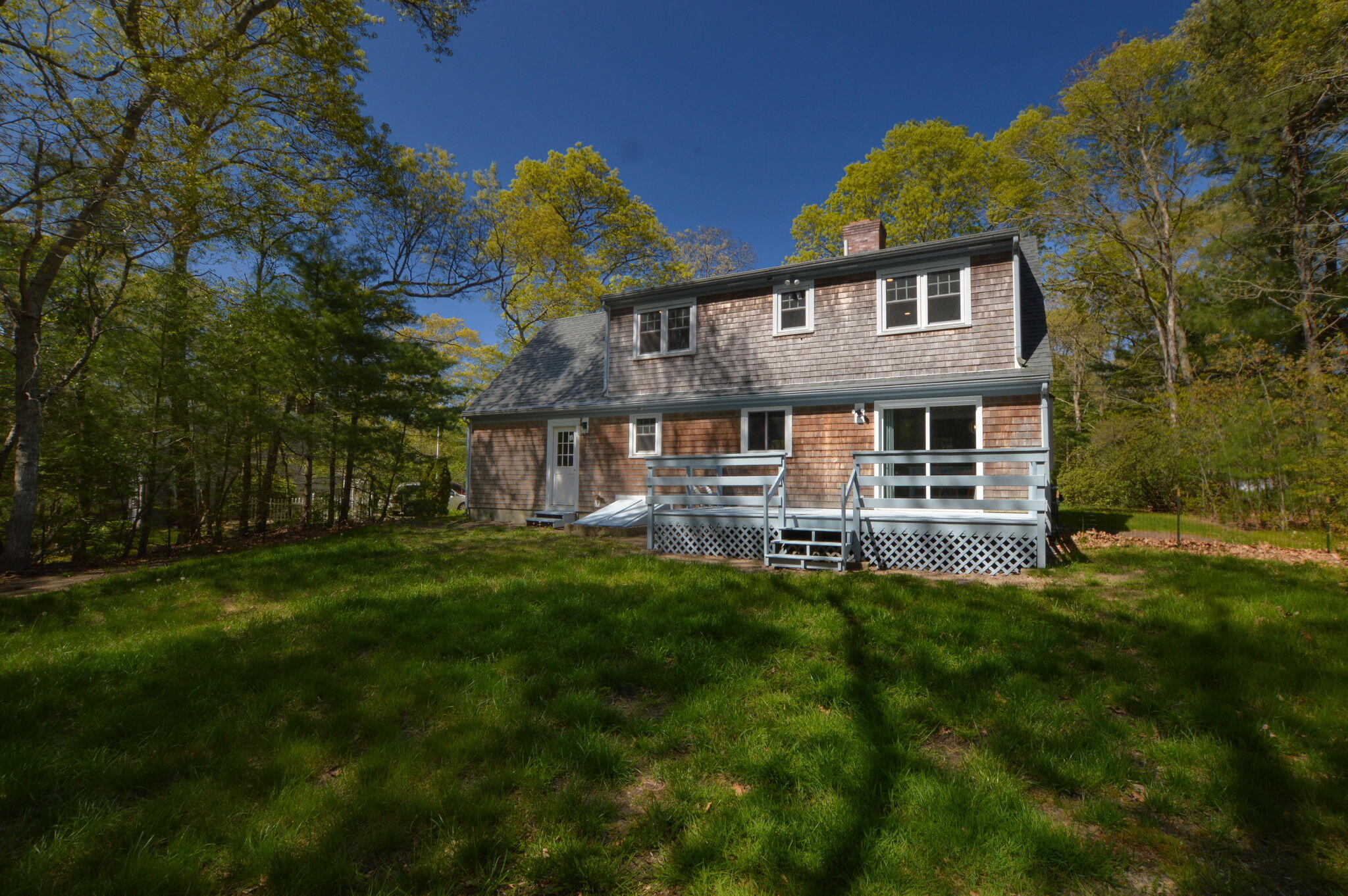 645 Lumbert Mill Road Centerville, MA 02632 - Photo 23 of 30 a view of a house with a backyard porch and sitting area