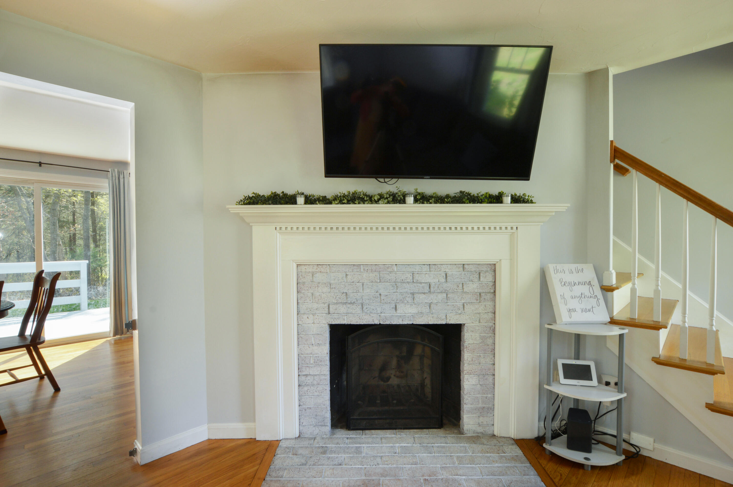645 Lumbert Mill Road Centerville, MA 02632 - Photo 5 of 30 a living room with a fireplace and a flat screen tv
