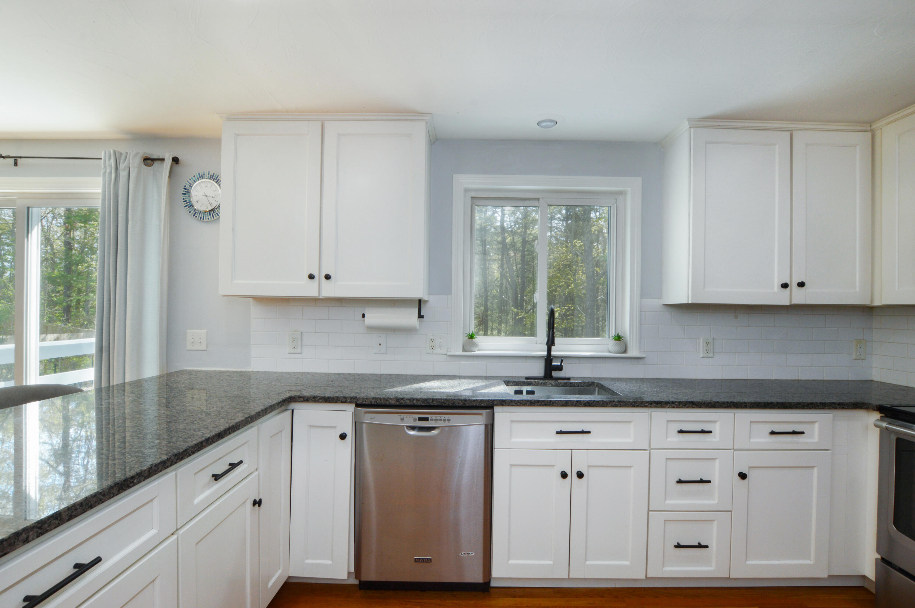 645 Lumbert Mill Road Centerville, MA 02632 - Photo 8 of 30 a kitchen with granite countertop white cabinets and a window