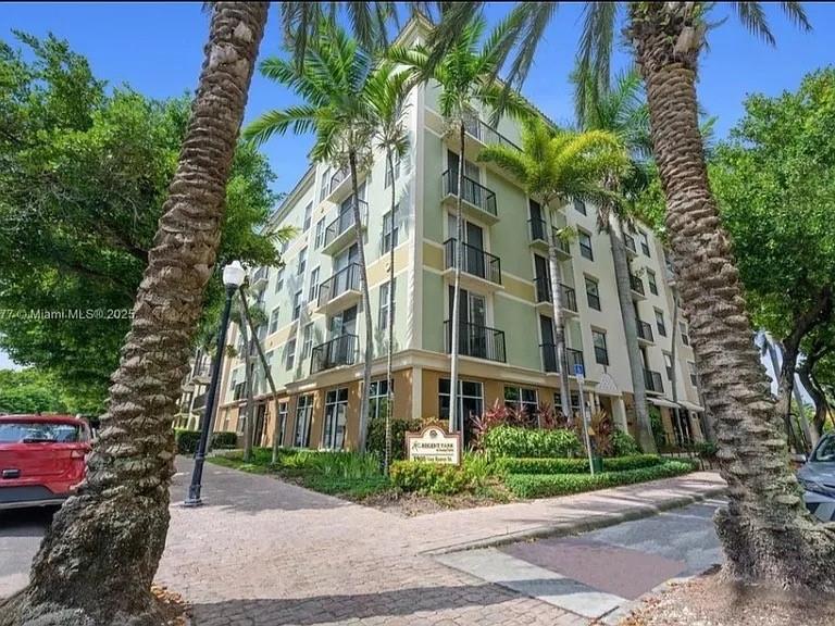 1919 Van Buren Street, Unit 609 Hollywood, FL 33020 - Photo 1 of 15 a front view of a multi story building with a yard