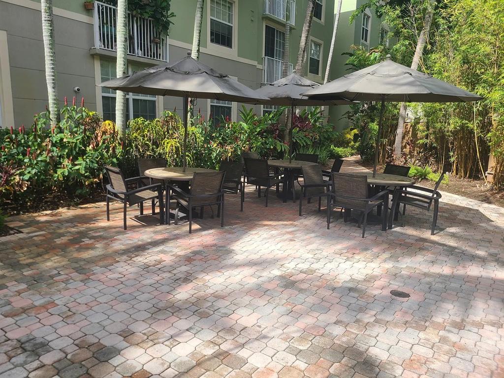 1919 Van Buren Street, Unit 609 Hollywood, FL 33020 - Photo 11 of 15 a view of a patio with table and chairs under an umbrella
