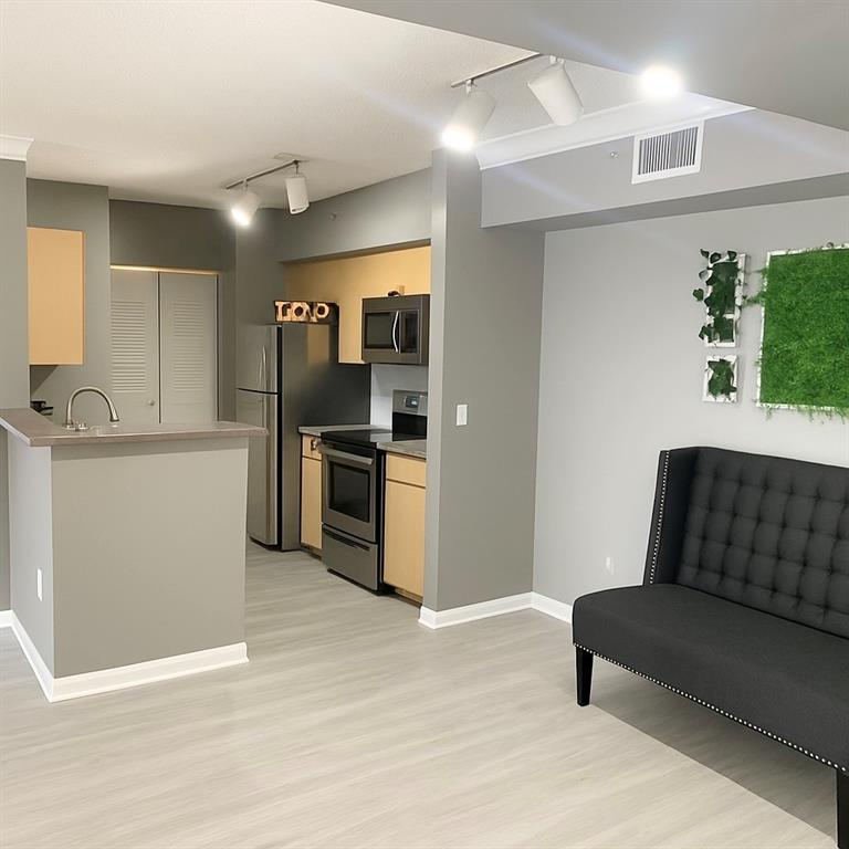 1919 Van Buren Street, Unit 609 Hollywood, FL 33020 - Photo 13 of 15 a kitchen with stainless steel appliances kitchen island granite countertop a refrigerator and a sink