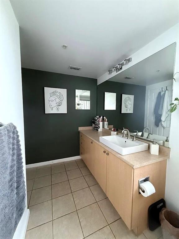 1919 Van Buren Street, Unit 609 Hollywood, FL 33020 - Photo 14 of 15 a view of a bathroom with sink and mirror