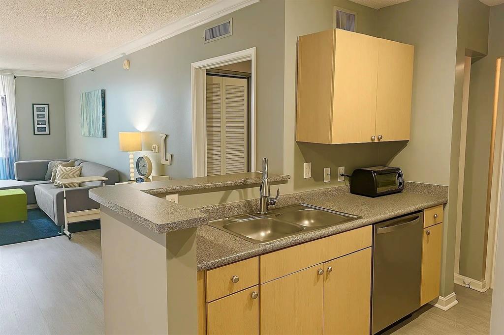 1919 Van Buren Street, Unit 609 Hollywood, FL 33020 - Photo 3 of 15 a kitchen with a sink and a refrigerator