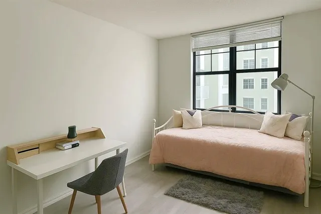 a bedroom with a bed and a window