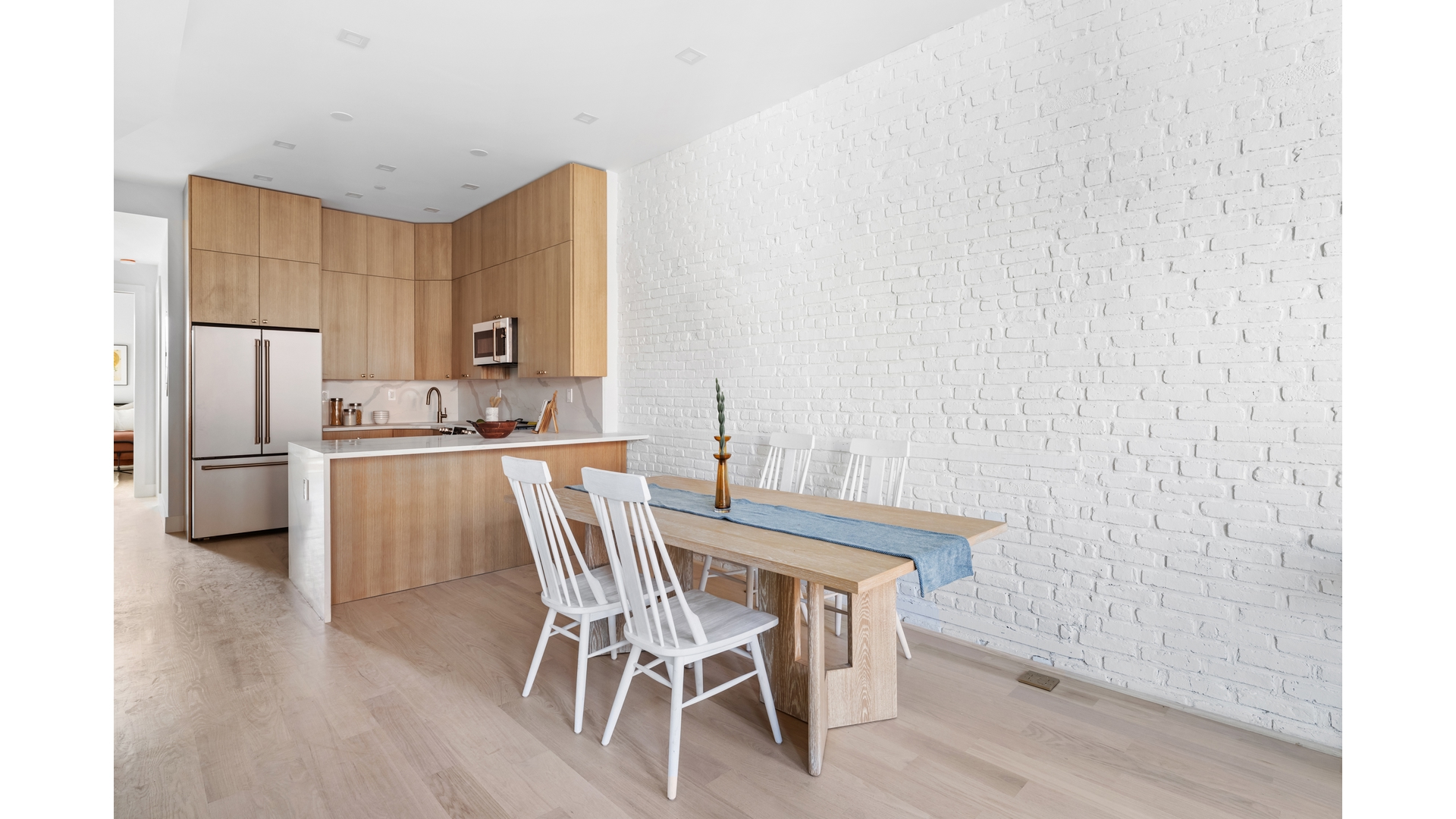 112 Luquer Street, Unit 2 Brooklyn, NY 11231 - Photo 2 of 11 a kitchen with stainless steel appliances a refrigerator a stove a sink with white cabinets and wooden floor