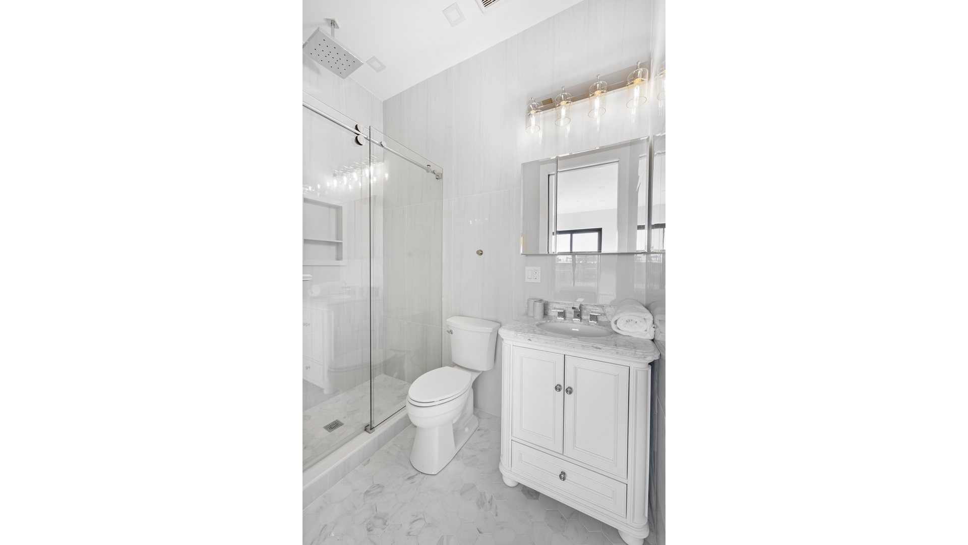 112 Luquer Street, Unit 2 Brooklyn, NY 11231 - Photo 8 of 11 a bathroom with a granite countertop toilet a sink and a mirror