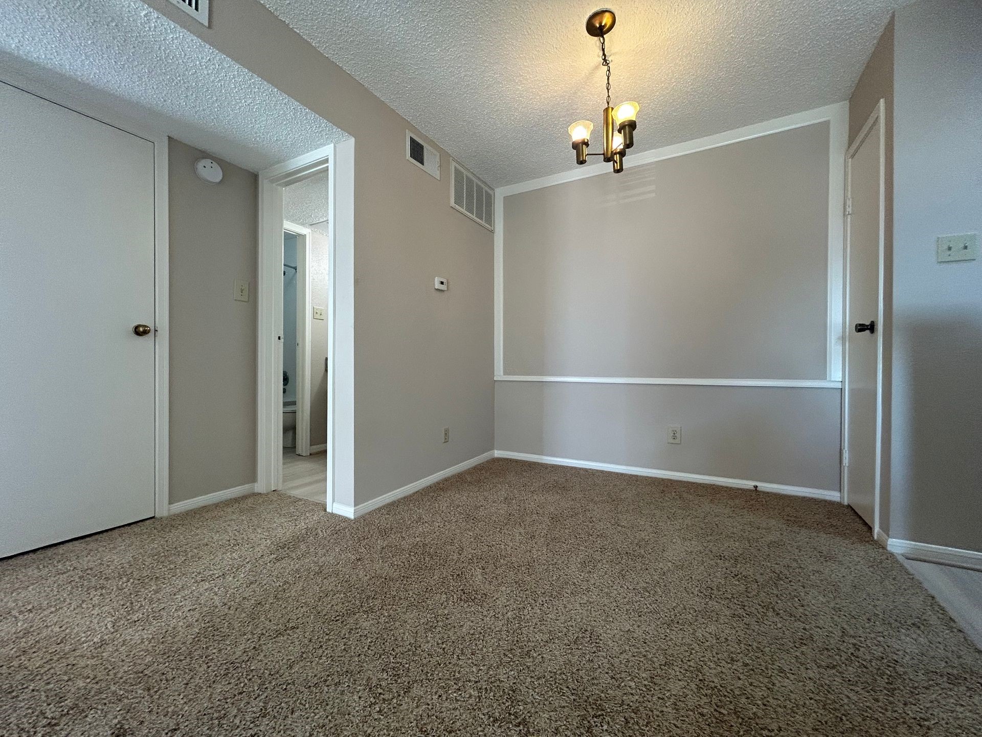 12550 Whittington Drive, Unit 610 Houston, TX 77077 - Photo 2 of 10 a view of an empty room with a chandelier