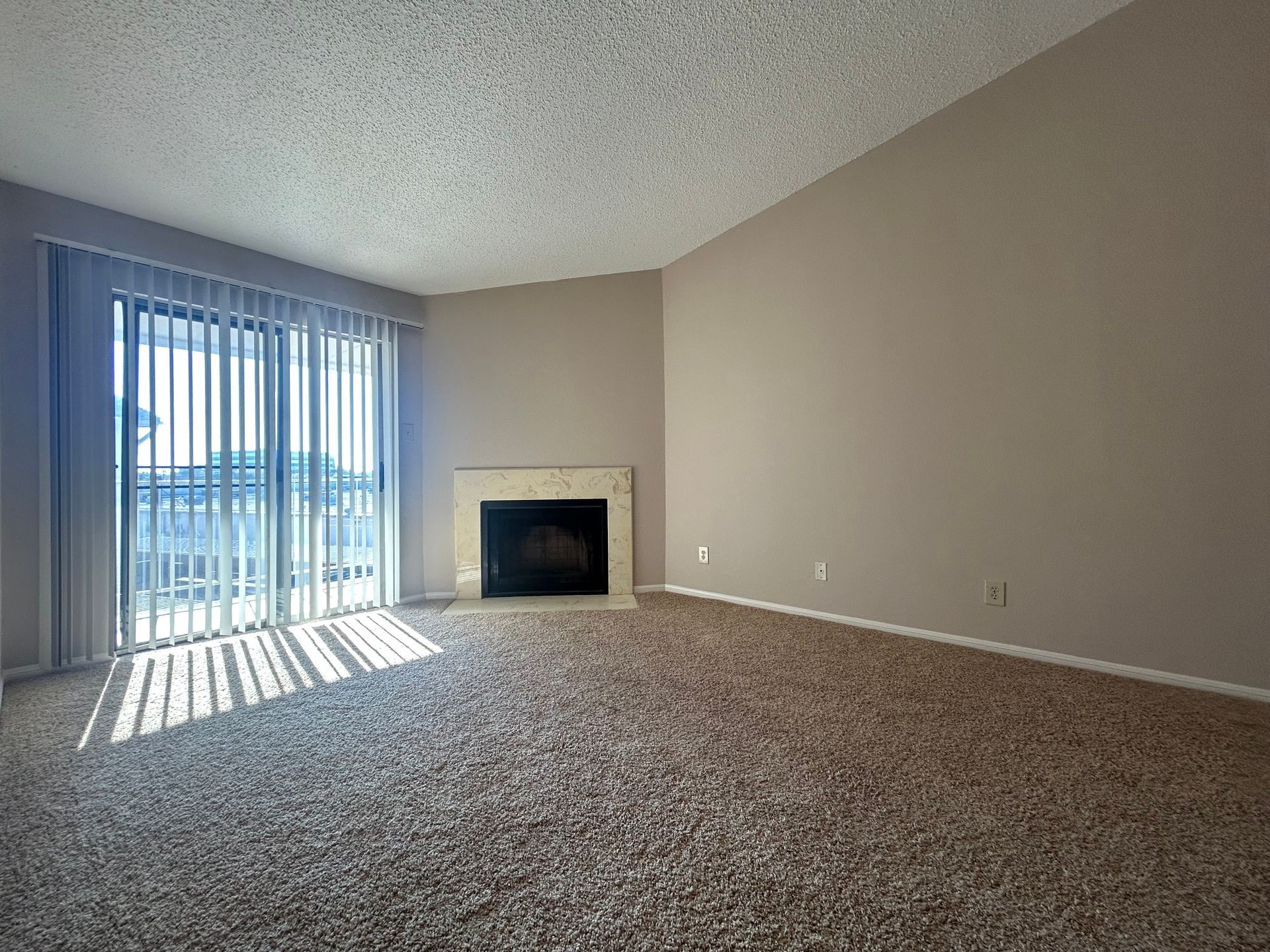 12550 Whittington Drive, Unit 610 Houston, TX 77077 - Photo 4 of 10 a view of an empty room with a fireplace