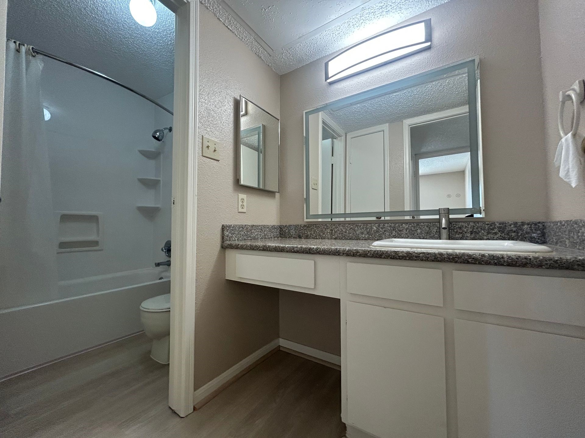12550 Whittington Drive, Unit 610 Houston, TX 77077 - Photo 6 of 10 a bathroom with a sink a toilet and a large mirror