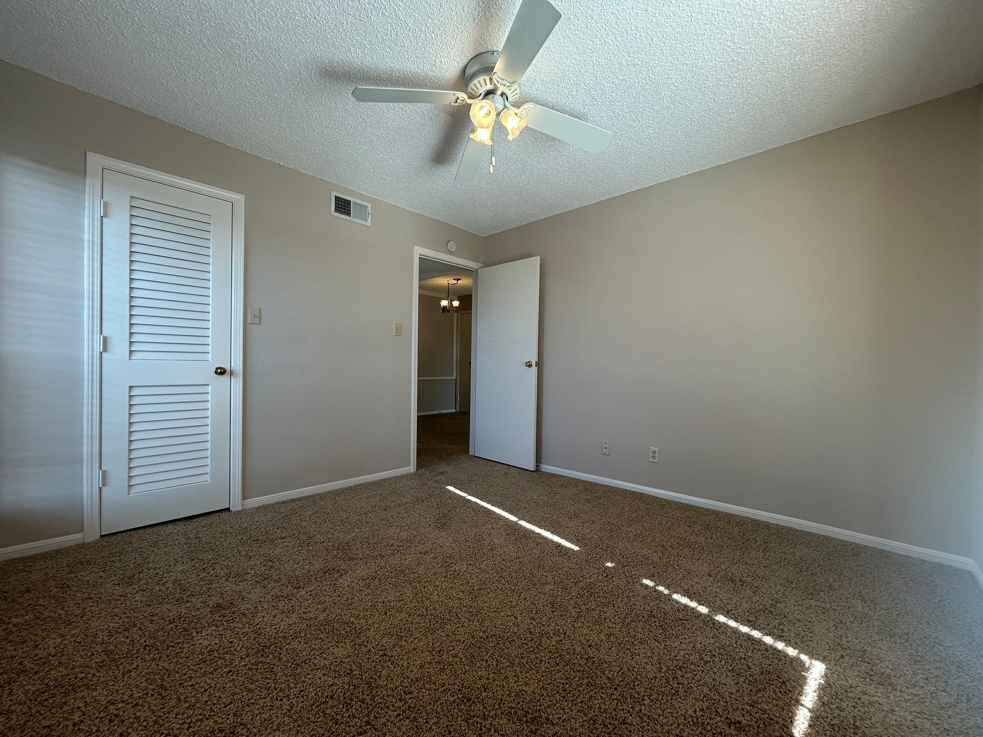 12550 Whittington Drive, Unit 610 Houston, TX 77077 - Photo 7 of 10 an empty room with closet and a ceiling fan