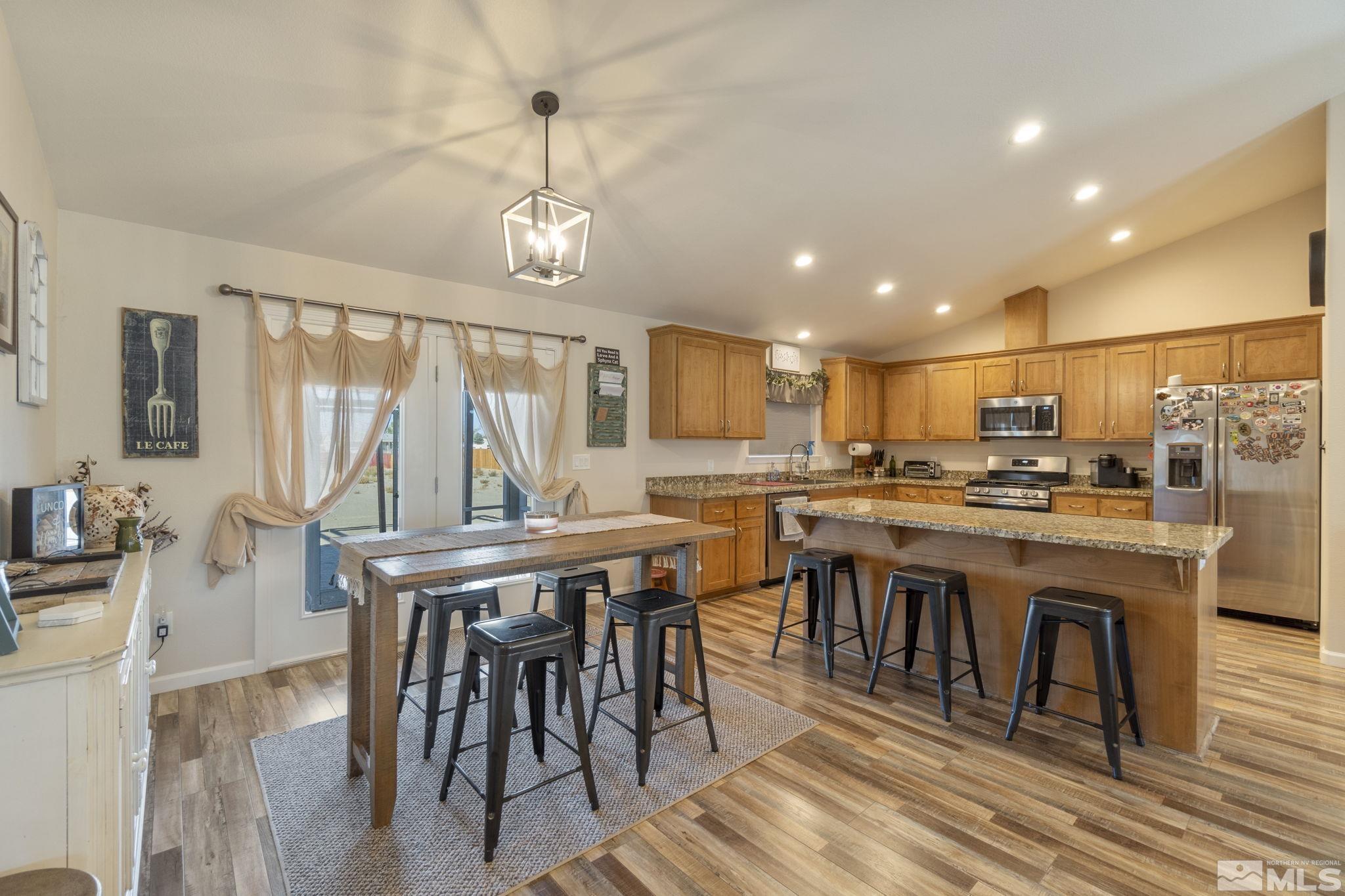 1837 Sky Ridge Drive Fallon, NV 89406 - Photo 17 of 34 a dining room with stainless steel appliances granite countertop a table chairs and a kitchen view