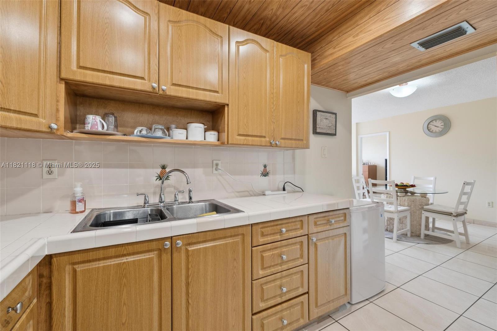 6705 Northwest 169th Street, Unit C310 Hialeah, FL 33015 - Photo 12 of 26 a kitchen with cabinets and sink