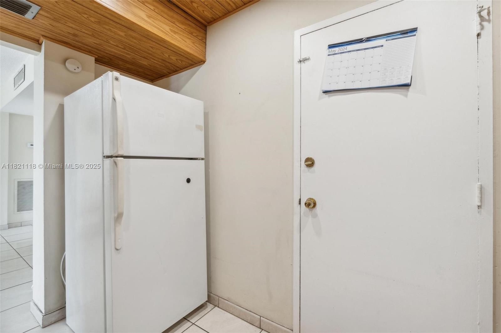6705 Northwest 169th Street, Unit C310 Hialeah, FL 33015 - Photo 13 of 26 a white refrigerator freezer and a granite counter top