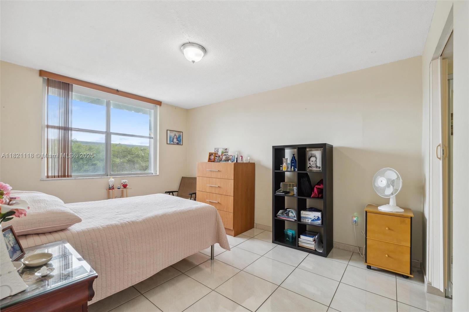 6705 Northwest 169th Street, Unit C310 Hialeah, FL 33015 - Photo 15 of 26 a bedroom with a bed and a window