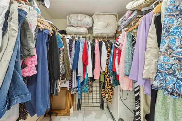 a view of walk in closet with clothes