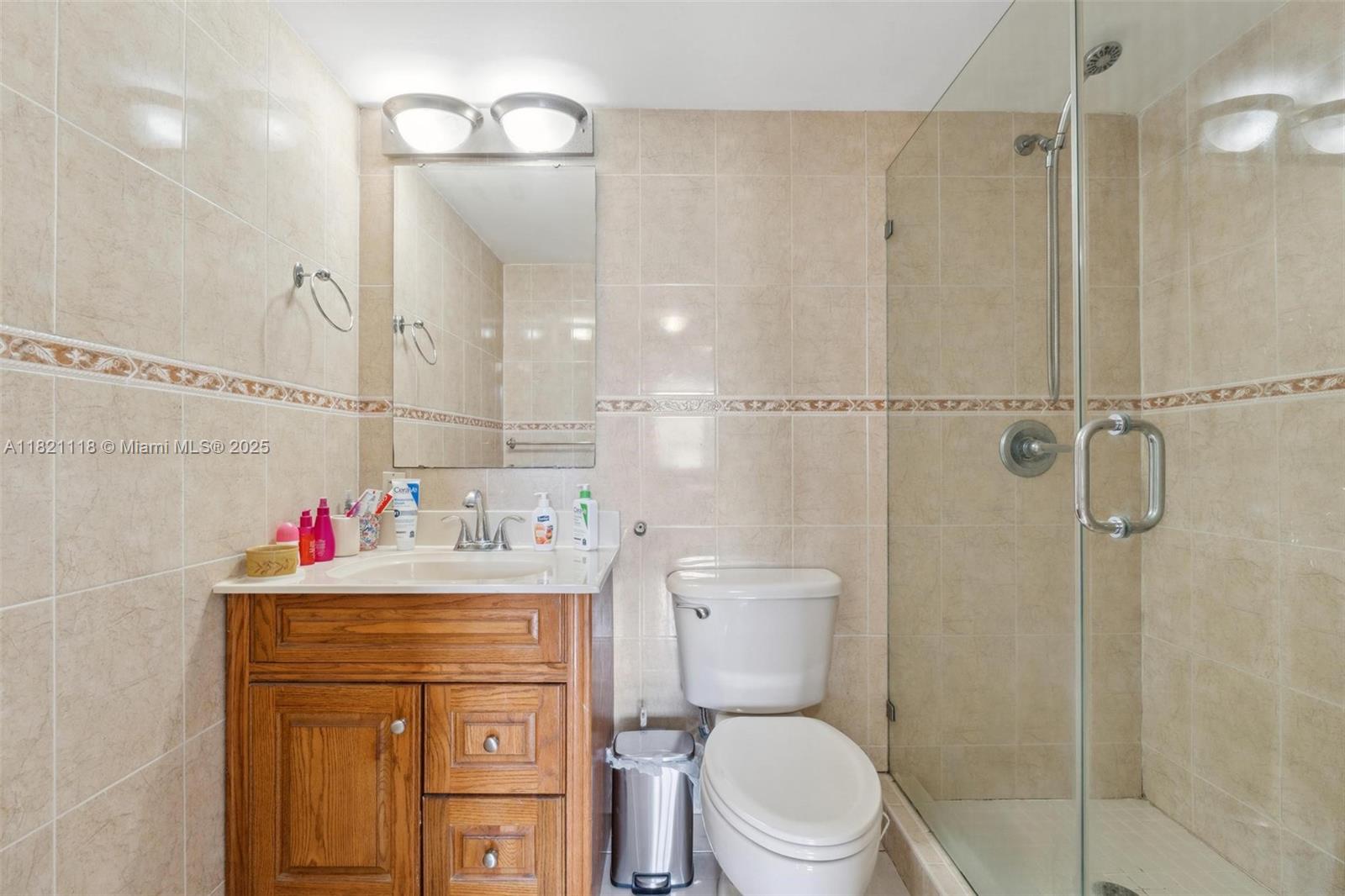 6705 Northwest 169th Street, Unit C310 Hialeah, FL 33015 - Photo 20 of 26 a bathroom with a sink toilet vanity and shower