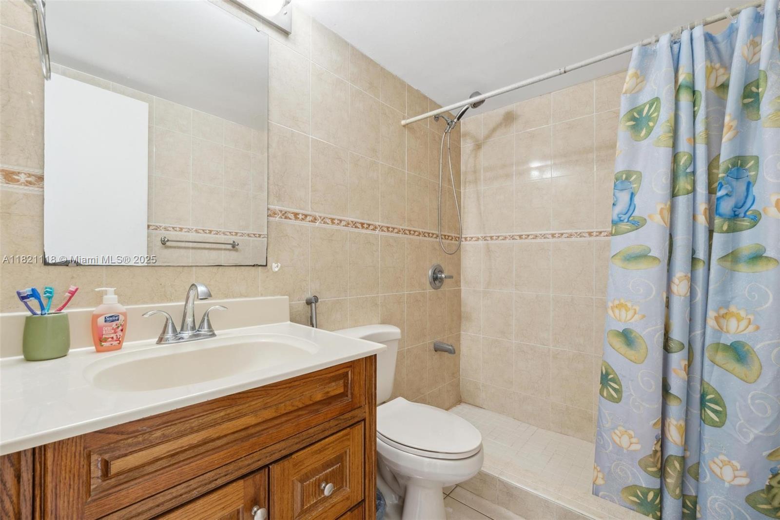 6705 Northwest 169th Street, Unit C310 Hialeah, FL 33015 - Photo 21 of 26 a bathroom with a sink toilet and shower