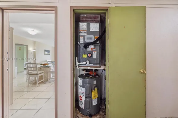 a view of a hallway with wooden floor and a bathroom