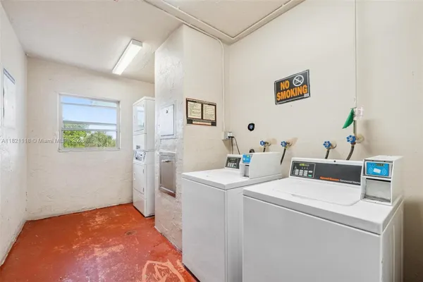 a view of washer and dryer with kitchen in the background