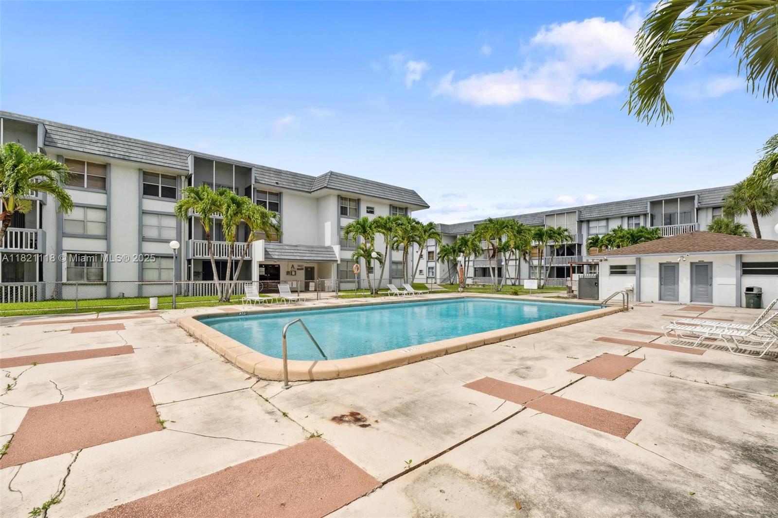 6705 Northwest 169th Street, Unit C310 Hialeah, FL 33015 - Photo 6 of 26 a view of a swimming pool with a patio