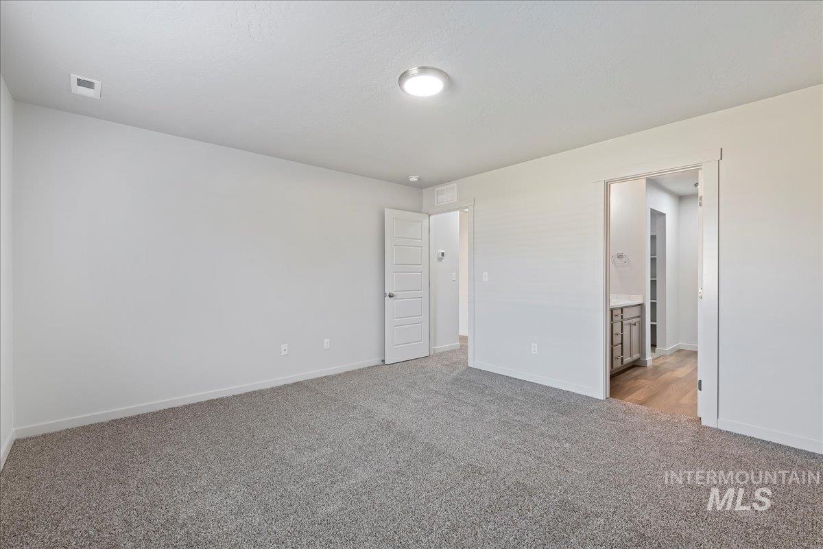 12732 West Fig Street Boise, ID 83713 - Photo 14 of 34 Unfurnished bedroom with light colored carpet and ensuite bath