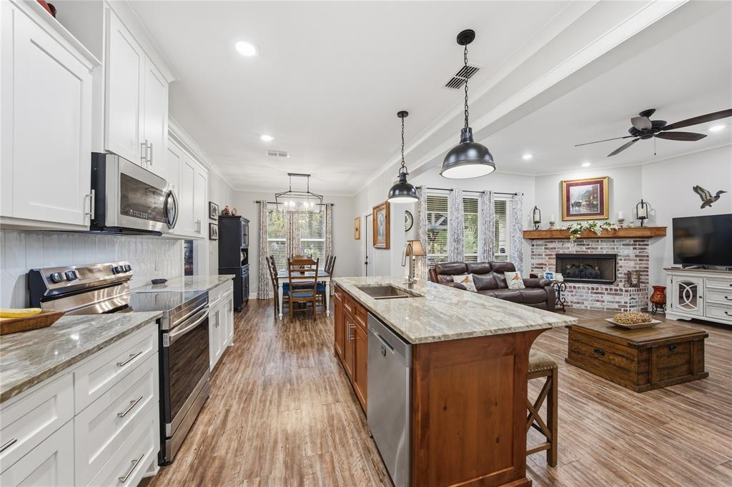 a kitchen with sink a stove and cabinets