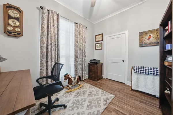 a view of a workspace with furniture and a window