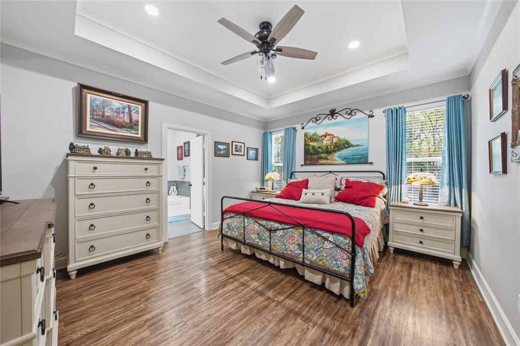 7222 Neches Street Athens, TX 75752 - Photo 15 of 27 a bedroom with a bed and a dresser