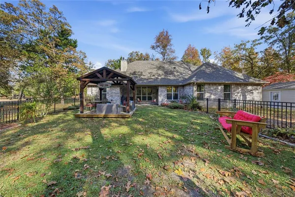 a view of a house with a backyard